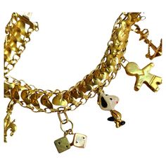 Vintage 1970s 18k gold bracelet with 6 dangling charms in very good condition hall marked and gold tested Yellow Gold Charm Bracelet With Dangle Shape, Yellow Gold-plated Charm Bracelet With Dangling Charms, Yellow Gold-plated Bracelets With Dangling Charms, Yellow Gold Plated Charm Bracelet With Dangling Charms, Yellow Gold Plated Bracelets With Dangling Charms, Yellow Gold Charm Bracelet With Dangling Charms, 14k Yellow Gold Charm Bracelet With Dangling Charms, Vintage Charm Yellow Gold Bracelet, Adjustable Yellow Gold Charm Bracelet