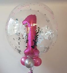 a balloon with a pink number one on it