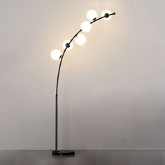 a lamp that is on top of a table next to a white wall and floor