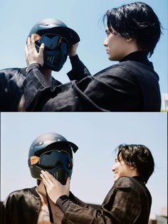 two people wearing helmets and one is holding the helmet up to his face