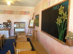 a classroom with desks, chairs and a chalkboard