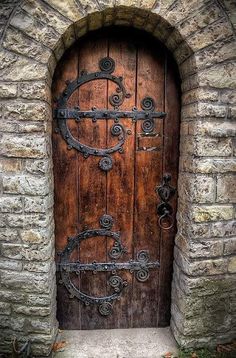 an old wooden door with iron work on it