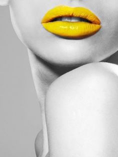 a woman with bright yellow lipstick on her face