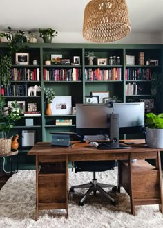 a home office with bookshelves, desk and computer on top of the desk