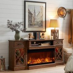 a living room with a fire place in the center and a painting on the wall