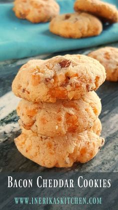 bacon cheddar cookies stacked on top of each other in front of a blue towel