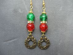 Inspired during the Christmas season these dangle earrings feature red and green crackle beads, a gold tone Christmas wreath charm, rhinestone spacer bead and gold tone findings.  From the top of the ear wire to the bottom of the wreath is approximately 2 3/4" and includes silicone stops to prevent loss.  A fun pair of earrings which can be worn to dress up a casual outfit or wear with jeans and a tee.  The earrings you will receive are the exact pair shown in the photo and are ready to ship.  D Holiday Beaded Dangle Jewelry, Holiday Jewelry With Dangling Beads, Beaded Dangle Christmas Jewelry, Christmas Beaded Dangle Jewelry, Red Round Beaded Earrings For Christmas, Red Round Beads Earrings For Christmas, Gold Round Beads Jewelry For Christmas, Gold Jewelry With Matching Earrings For Holiday, Christmas Dangling Bead Earrings