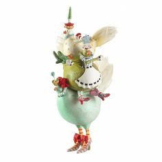 a glass ornament with some birds on it's head and wings in the shape of an egg