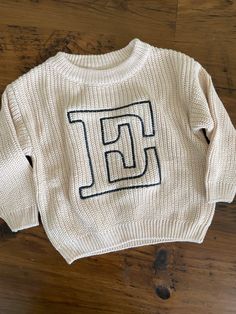 🌸embroidered letter sweaters are perfect for the little ones! Beige color sweaters professionally machine-embroidered. Chunky sweaters have a slightly oversized fit. in the personalization box: please write in the letter you'd like embroidered on the sweater (if you'd like a thread color other than black, please write that in the box as well!) for your little loves 💕 available in sizes 3m-4T message us for additional sizes! these sweatshirts make the best gift for any baby or toddler! Letter Sweater, Chunky Sweaters, Embroidered Initials, Toddler Sweater, Chunky Knit Sweater, Personalized Letters, Chunky Knits Sweater, Kids Sweater, Chunky Sweater