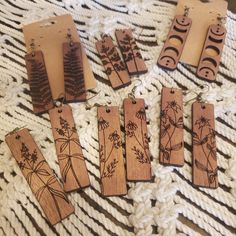 six wooden tags with designs on them sitting on a blanket