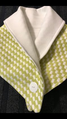 a green and white checkered tie with a white button