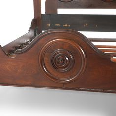 an antique wooden bed frame with carved details