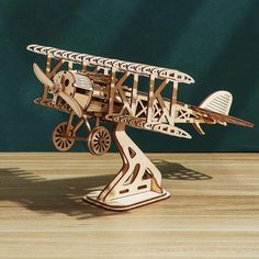 a wooden model of an airplane on a table