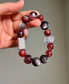 "Size: 11-14mm Material:  Hematoid Fire Quartz, Herkimer Diamond, Silver Sheen Obsidian, Peach Moonstone, 925 Sterling Silver Accessory Step into a world of natural beauty with my handcrafted gemstone bracelet!  🔥Hematoid Quartz promotes a serene mind, fostering improved thought patterns and heightened empathy. Enjoy its skincare benefits and radiate a healthy glow with regular wear. 💎Herkimer Diamond enhances spiritual awareness, achieve mental clarity, and nurture a calm and resolute consciousness. ✨Known as the \"lover's stone,\" Peach Moonstone softens the soul, fostering emotional serenity and alleviate communication-related conflicts, radiate charm, and exude a gentle aura. Embrace the magic of nature's gems and experience a blend of style and holistic well-being.  Only ONE availab Handmade Beaded Bracelets In Sterling Silver With Fusion Style, Sterling Silver Fusion Beaded Bracelets For Gifts, Sterling Silver Fusion Beaded Bracelets As Gift, Fusion Style Sterling Silver Beaded Bracelets As Gift, Silver Gemstone Crystal Bracelet For Meditation, Fusion Style Beaded Bracelet Gift, Fusion Style Round Beaded Bracelets As Gift, Fusion Style Round Beaded Bracelet Gift, Fusion Style Hand-strung Beaded Bracelets As Gift