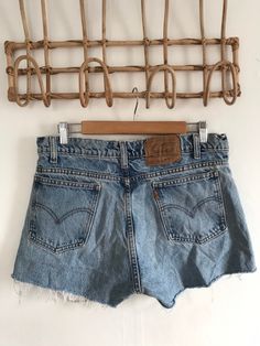 "Waist:32\" Rise:11.5\" Hips:39\" Inseam:2\" These are shown on a size 32\" model and are tagged a 34\" but are true vintage and run small. They're rad 90's 505 cutoffs with the rare orange Levis tab and tons of distress and rips by the raw hem. They're the perfect edgy summer shorts to pair with your Harley crops and band tees. 🍑(15)" Cutoff Jean Shorts With Pockets, Retro Cutoff Shorts With Frayed Hem, Vintage Cutoff Jeans For Summer, Retro Cutoff Jean Shorts For Spring, Retro Spring Jean Shorts With Frayed Hem, Vintage Cutoff Jean Shorts In Medium Wash, Vintage Medium Wash Cutoff Jean Shorts, Distressed Cutoff Jean Shorts, High Rise Vintage Jean Shorts With Frayed Hem