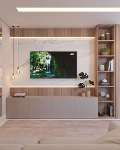 a living room filled with furniture and a flat screen tv mounted on the wall above it