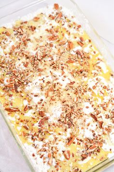 a casserole dish with nuts and cream in it