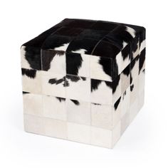 a black and white cowhide cube stool