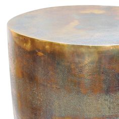 a round metal table with gold pattered paint