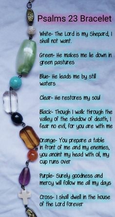 a poem written in the language of jesus on a white sheet with beads and stones