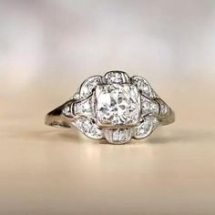 an old - fashioned diamond ring is shown in this image, with the center stone surrounded by smaller diamonds