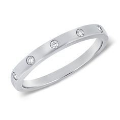 This 14K Gold Bezel & Channel Set Ring is a masterpiece of elegance. Featuring 0.06 carats of sparkling diamonds, the ring is designed with a seamless blend of bezel and channel settings that showcase the diamonds' brilliance while ensuring a sleek, modern look. The diamonds are meticulously placed to create a subtle yet captivating sparkle that catches the eye. Available in 14K white, yellow, or rose gold, this ring is perfect for stacking or wearing alone as a refined statement piece. Its vers Formal Diamond Eternity Band With Single Diamond, Bezel Set Cubic Zirconia Diamond Ring, Diamond Eternity Band With Bezel Setting, Elegant Diamond Stackable Rings With Bezel Setting, Elegant Stackable Rings With Smooth Bezel For Anniversary, Diamond Stackable Rings With Bezel Setting For Promise, Anniversary Diamond Ring With Smooth Bezel, Fine Jewelry Diamond Eternity Band With Bezel Setting, Modern Stackable Rings With Diamond Accents For Formal Occasions