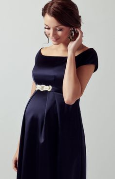 If you’re looking for a statement dress then our Aria long midnight maternity gown will guarantee you a show-stopping entrance. In rich navy satinesque fabric that drapes to the floor, the effect is dramatic and eternally stylish. From the gentle darts and concealed zip at the bust flows a beautiful skirt that pleats over your bump then cascades away to the floor in a full-length skirt with plenty of movement. Simply magnificent - just add our sparkling Aurelia sash to finish. Bardot neckline Fu Pregnacy Fashion, Elegant Maternity Dresses, Maternity Evening, Pink Maternity Dress, Maternity Dress Outfits, Cute Maternity Dresses, Tiffany Rose, Dresses For Pregnant Women, Preggo Fashion