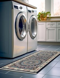 a washer and dryer in a room with tile flooring on the ground