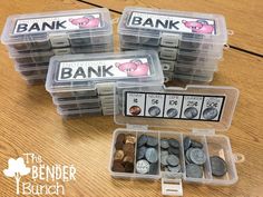 four plastic containers filled with different types of buttons and coins on a wooden table next to each other