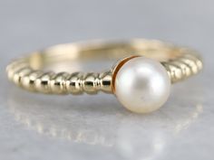 The perfect gift for a Sweet Sixteen or a June Birthday, this simple solitaire would look well stacked with other rings or bands, as well. Versatile and lovely, this will be a perfect wardrobe basic for years to come. Metal: 14K Yellow Gold Gem: Pearl Gem Measurements: 5.7 mm, Round Ring Size: 5.75 Marks: "14KT" Stamped on the inside band Fine Jewelry Stackable Pearl Ring With Round Band, Stackable 14k Gold Pearl Ring With Round Band, Elegant 14k Gold Stackable Pearl Ring, Stackable White Gold Pearl Ring With Round Band, Stackable Pearl Ring In White Gold With Round Band, Classic Yellow Gold Pearl Ring With Round Band, Stackable 14k Gold Pearl Ring Fine Jewelry, Formal Stackable Pearl Ring, Fine Jewelry, 14k Gold Stackable Pearl Ring Fine Jewelry