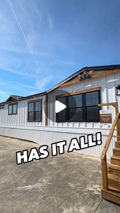 a mobile home with the words has it all written in front of it and stairs leading up