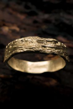 a gold wedding band that has been carved into it