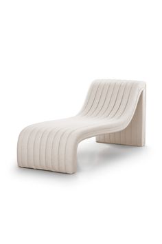 a white lounge chair sitting on top of a white floor