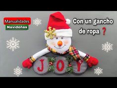 a snowman is holding a joy sign with the words joy written in spanish on it