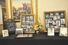 a table topped with pictures and framed photos