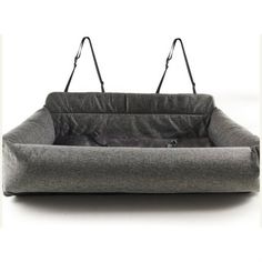 a gray dog bed with two black leashes hanging from it's back end