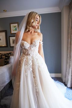 a woman in a wedding dress looking down