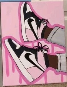 a pair of sneakers painted on a pink box