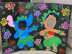 an image of two cartoon characters painted on a black board with flowers and leaves in the background