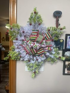 a christmas wreath is hanging on the wall