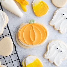 decorated cookies with icing and decorations on a cooling rack next to other cookie items