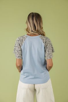 I love a little detail in my wardrobe and this blouse fits the bill! Featuring a dusty blue color and floral sleeves, the To The Lakes Detail Blouse is simple and beautiful. unlined Fall Floral Print Light Blue Top, Fall Light Blue Floral Print Top, Blue Floral Print Crew Neck Blouse, Blue Raglan Sleeve Tops For Spring, Light Blue Short Sleeve Blouse For Fall, Spring Cotton Tops With Contrast Sleeves, Fall Light Blue Short Sleeve Blouse, Casual Tops With Contrast Sleeves For Spring, Dusty Blue Color