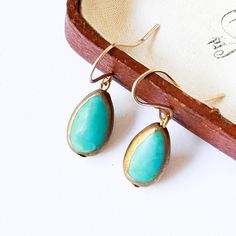 A beautiful pair of 0.5" small genuine Turquoise stone earrings dipped in gold around the edges. The ear wires are 24K gold plated. The details: Real turquoise  24K Gold plated ear wires  Shipped in a gift box. Handmade in Vermont Turquoise Earrings Gold, Turquoise Stone Earrings, Turquoise Drop Earrings, Real Turquoise, Box Handmade, Earrings Turquoise, Slippers Cozy, Genuine Turquoise, Turquoise Earrings