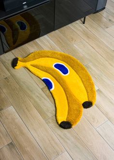 a yellow rug with three bananas on it