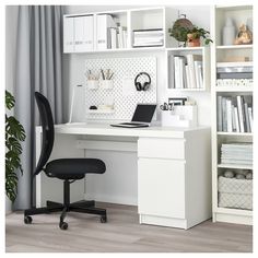 a white desk with a black chair in front of it