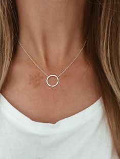 "This is a beautiful and delicate necklace that has a hammered sterling silver ring in the middle of a sterling silver chain. Or a hammered 14k gold fill ring in the center of a 14k gold fill chain. This necklace is perfect for layering or can be worn alone as it is shown here.  Pictured:  1st two pictures - 16\" 2nd picture - 18\" Matching Bracelet: https://www.etsy.com/listing/240465287/hammered-infinity-circle-in-1420-gold?ref=shop_home_active_10" Simple Silver Necklace, Hammered Sterling Silver, Gold Filled Ring, Matching Bracelet, Circle Necklace, Hammered Silver, Matching Bracelets, Delicate Necklace, Sterling Silver Chain