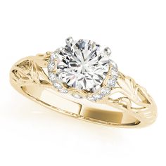 a yellow gold engagement ring with an intricate design