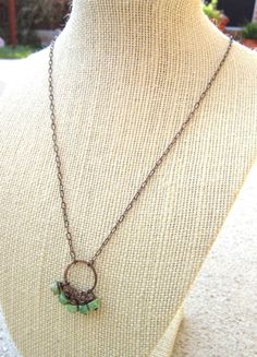 "This delicate genuine turquoise necklace is made up of five copper wire wrapped genuine green turquoise stones. They freely dangle from a 3/4\" diameter hammered copper circle. The necklace has a copper peanut link chain and a copper lobster claw clasp. Choose from 16\", 18\" or 20\". If you would like another length, please convo me. All my jewelry comes gift boxed with a bow ready for gift giving, whether it is a gift for you or someone special. Thank you for visiting Jen's Bead Box Jewelry!" Adjustable Wire Wrapped Turquoise Necklace With Round Beads, Handmade Green Turquoise Round Necklace, Turquoise Wire Wrapped Round Necklace, Hand-strung Round Turquoise Necklace As Gift, Green Bohemian Copper Wire Necklace, Unique Wire-wrapped Turquoise Pendant Necklace, Howlite Necklace, Jewelry Rustic, Vert Turquoise