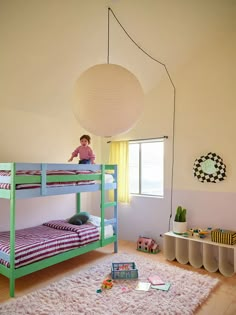 a child's bedroom with bunk beds and rugs