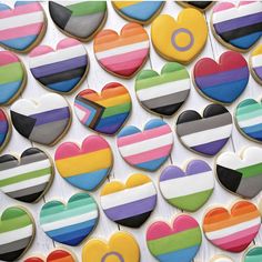 colorful heart shaped cookies are arranged on a table